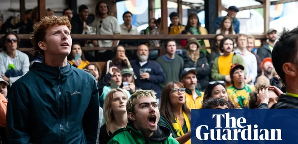 Agroup of fans watching a sports event indoors