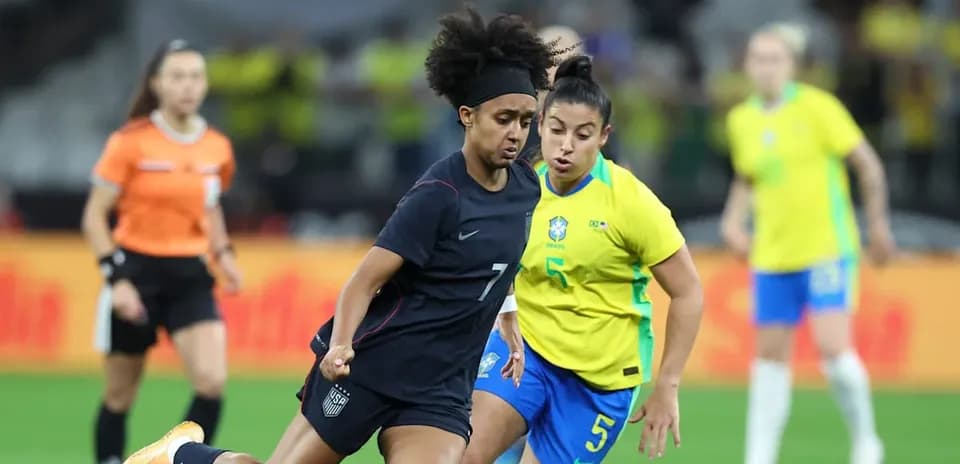 Jugadoras de Estados Unidos y Brasil compiten por el balón
