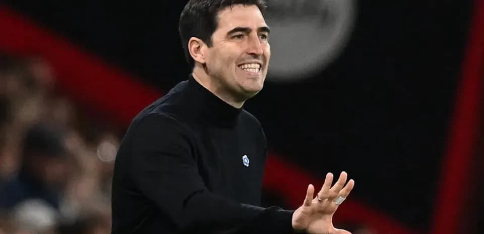 Entrenador gesticulando durante un partido de fútbol