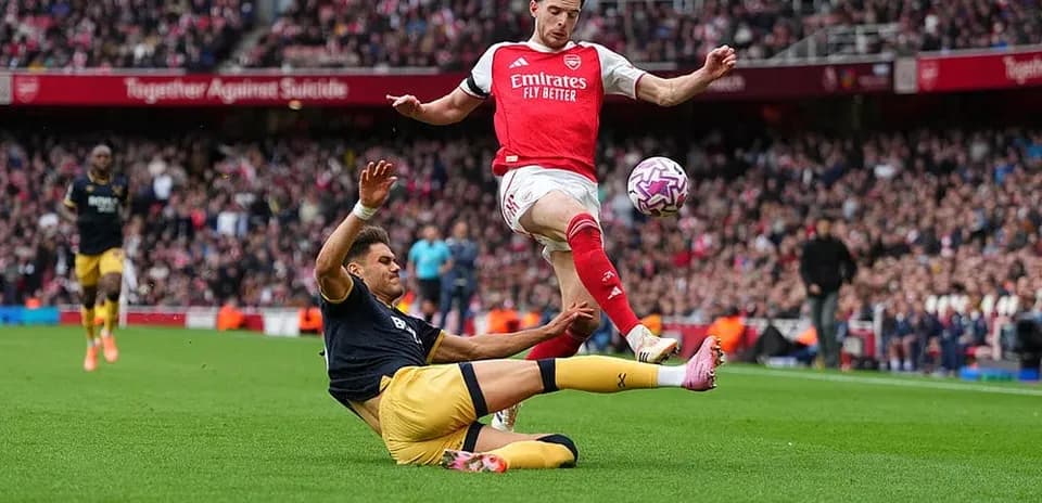 Jugador de Arsenal saltando sobre rival de West Ham