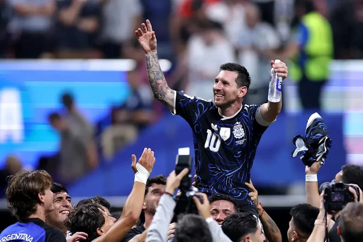 Lionel Messi siendo levantado por compañeros de equipo