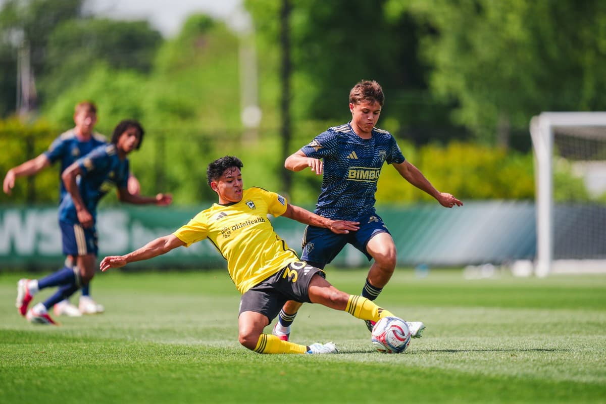 Jugador de Columbus Crew II derrapando en el campo
