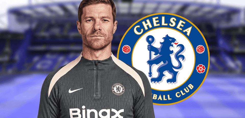 Entrenador de Chelsea posando con el logo del club