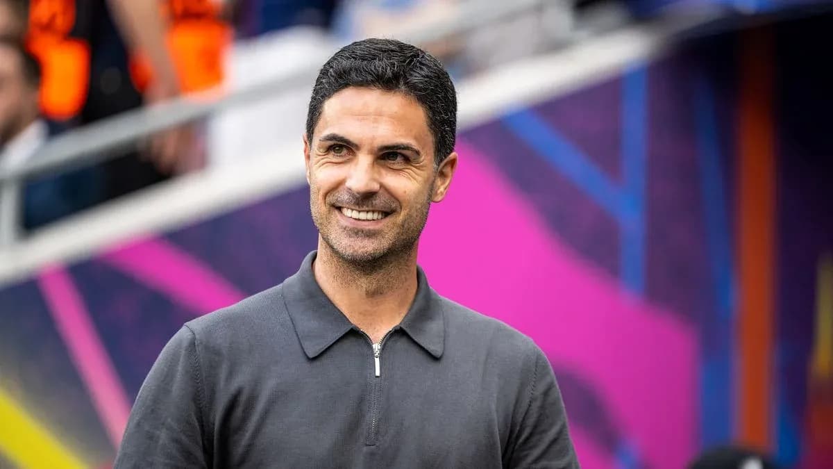 Entrenador sonriendo en el estadio antes del partido